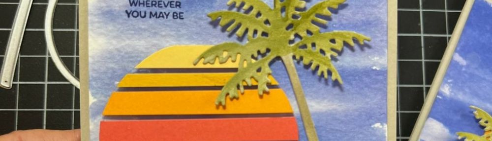 handmade card with a multicolored semi circle on a blue watercolor wash background with a palm tree and the words Hope you find a little paradise wherever you may be