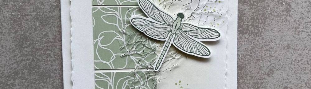 a white card with 3 soft green squares and a dragonfly