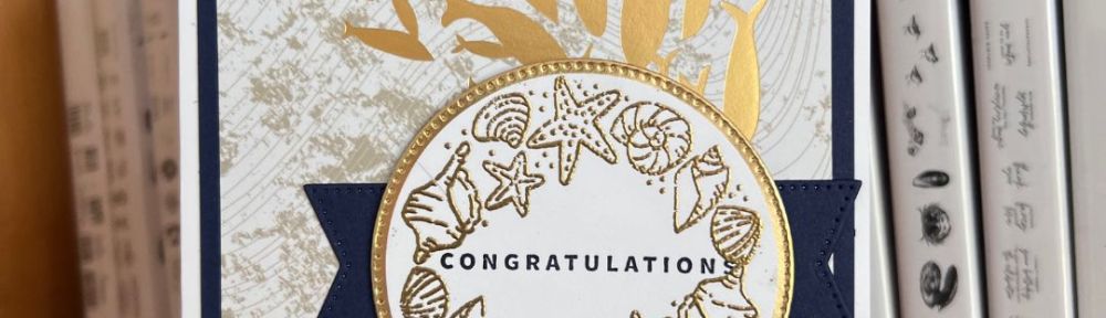 white card with gold school of fish and congratulations message