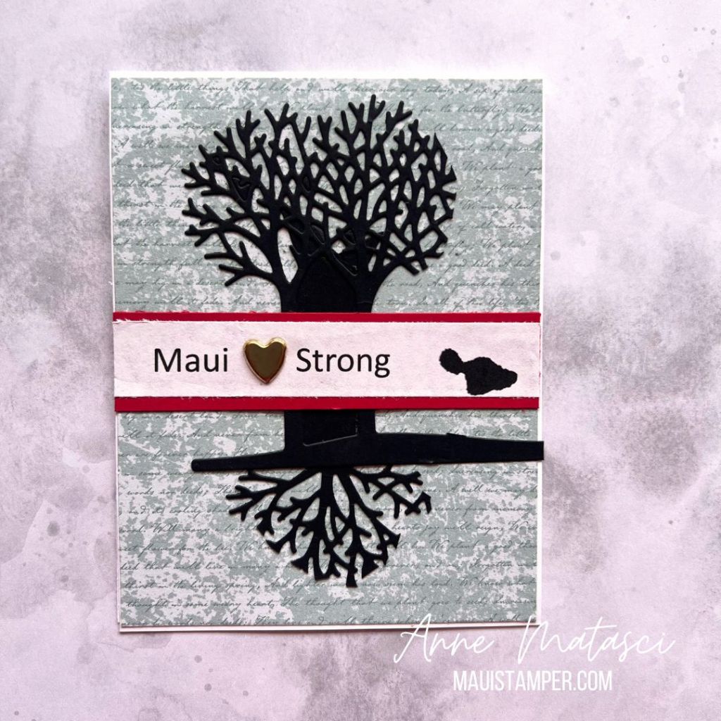 An outline of a black tree with a banner and the text "Maui Strong"
