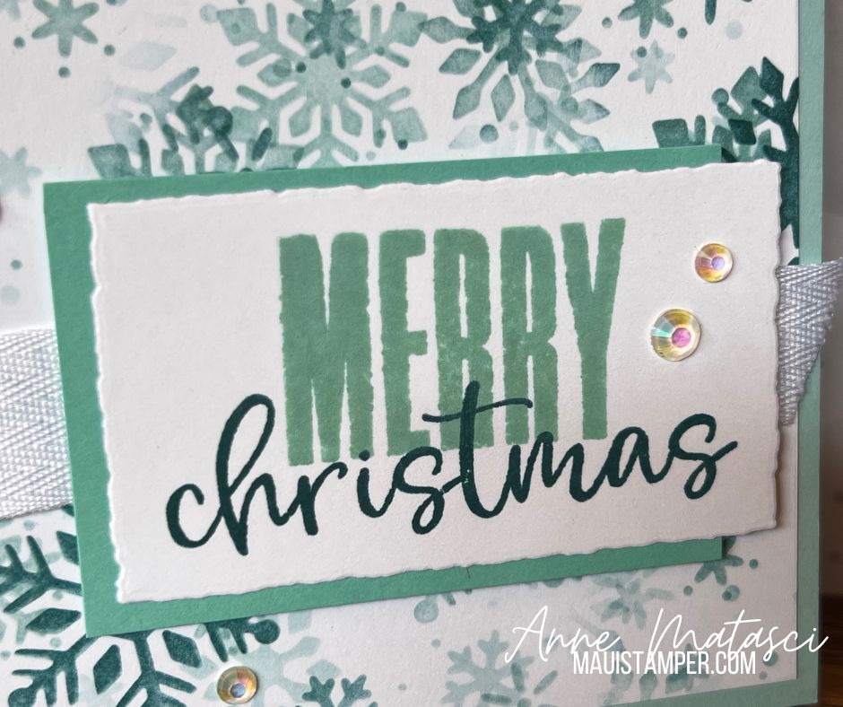 A handmade card with a snowflake pattern and the text “Merry Christmas”
