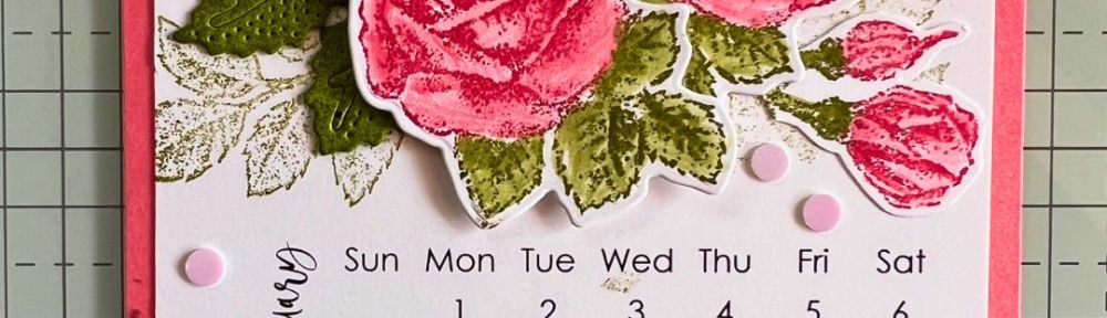 A handmade calendar page for January with the pink roses and green leaves