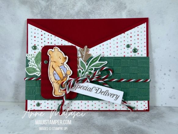 An open envelope with Winnie the Pooh and Christmas Greenery
