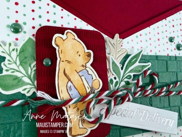 An open envelope with Winnie the Pooh and Christmas Greenery