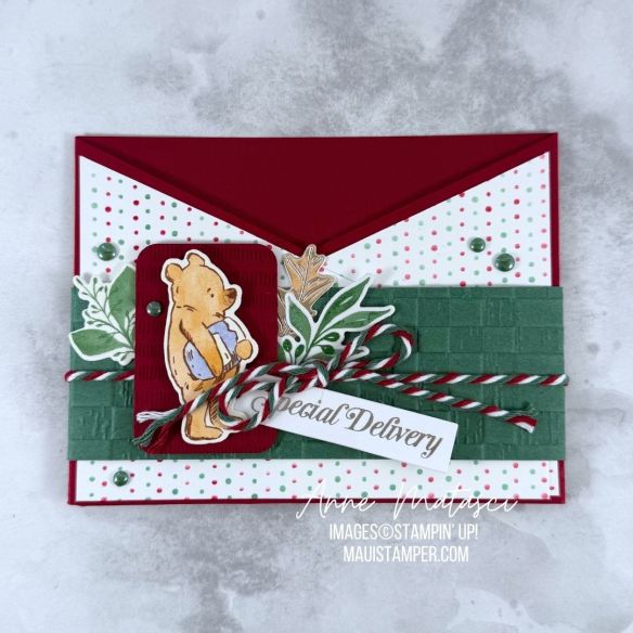 An open envelope with Winnie the Pooh and Christmas Greenery
