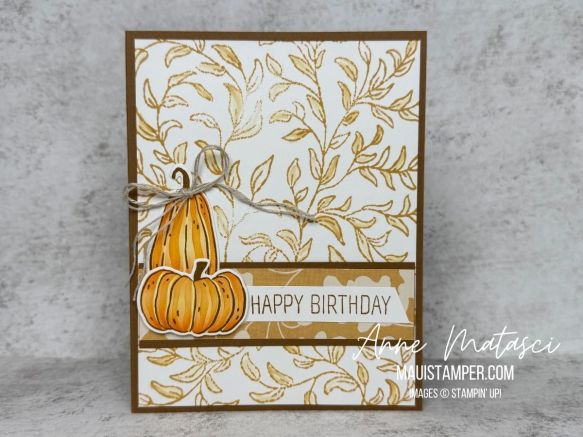 A card with a golden leafy background and two pumpkins