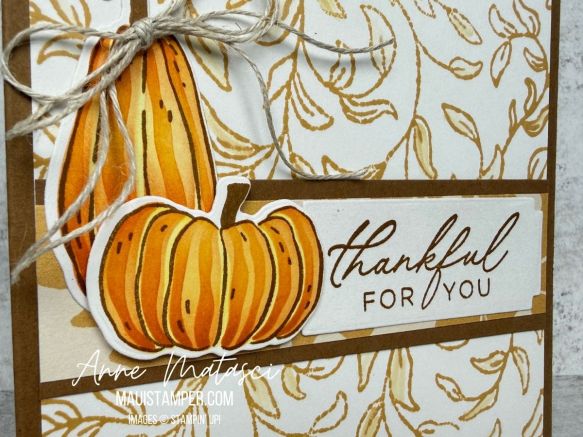 A card with a golden leafy background and two pumpkins