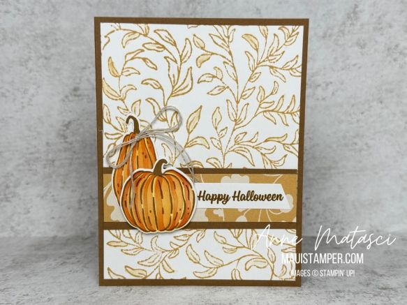 A card with a golden leafy background and two pumpkins
