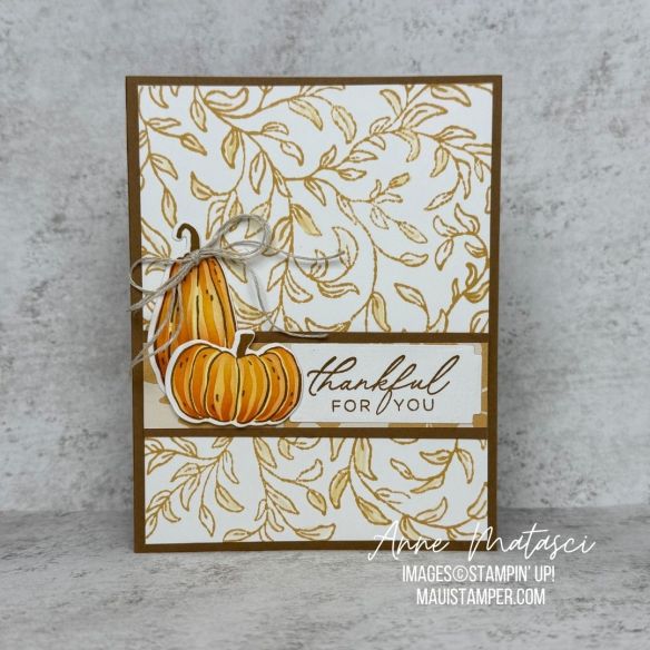 A card with a golden leafy background and two pumpkins